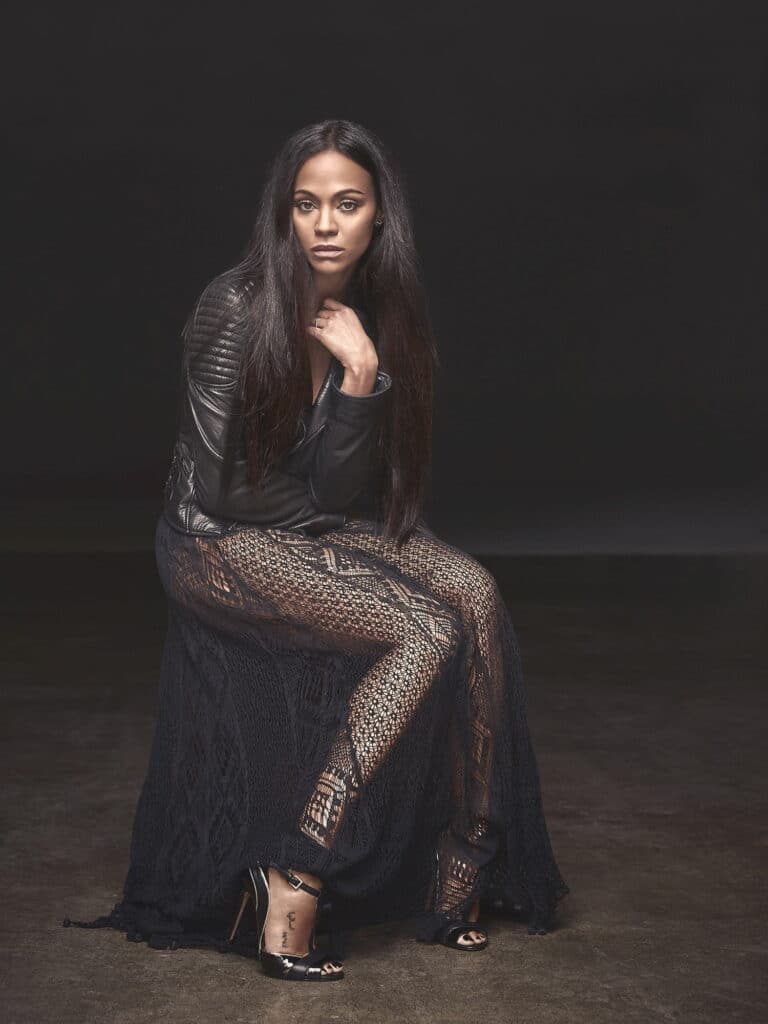 Zoe Saldaña: Wears a black lace dress with sheer details, paired with a jacket…