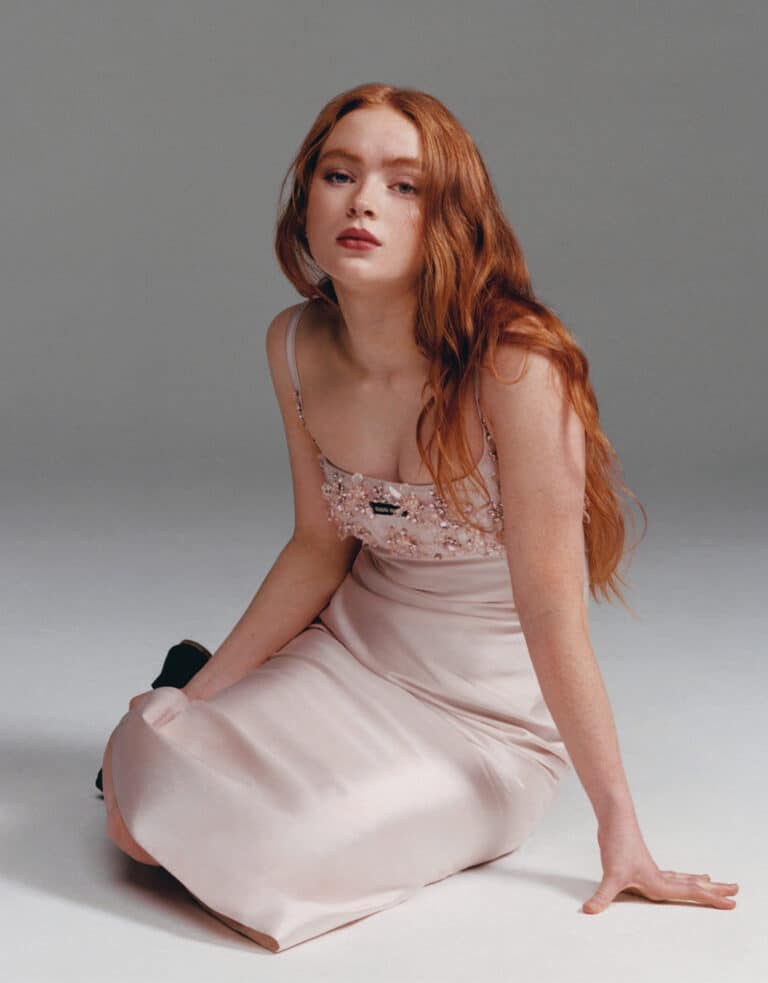 Sadie Sink: The outfit is a light pink dress with thin straps and details…