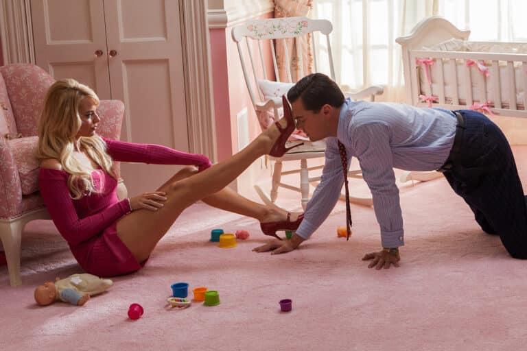 Margot Robbie: Wears a short pink dress and high heels. Long hair…