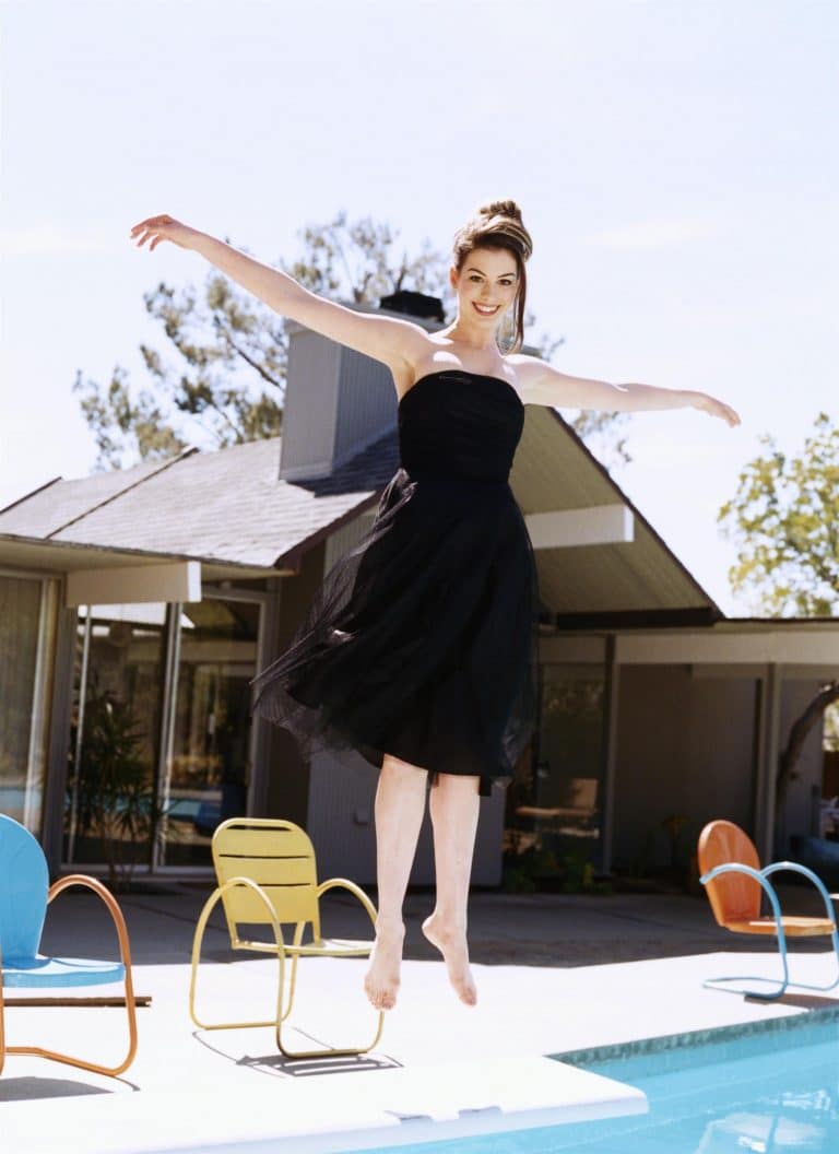 Anne Hathaway: Wearing a black strapless dress and barefoot. Hair pulled back in…