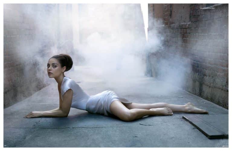Mila Kunis: Wears a short white dress and has her hair styled in an elegant bun.…