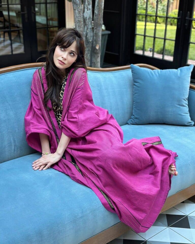 Zooey Deschanel: Wears a long fuchsia dress with black details. Barefoot and…