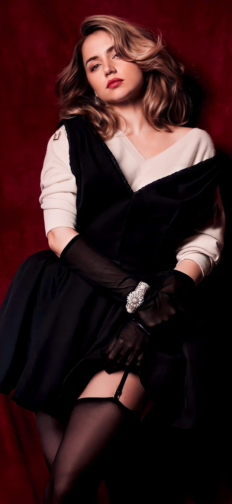 Ana de Armas: Wears a black dress over a white long-sleeve sweater. Wears black gloves…