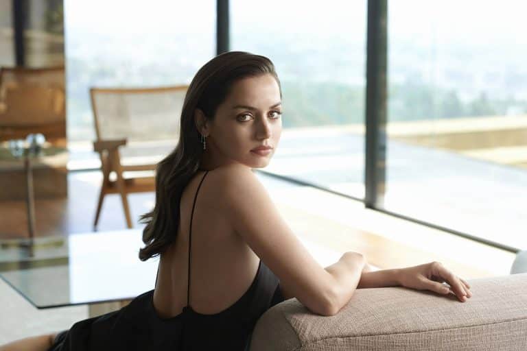 Ana de Armas: No footwear visible. Wears a black dress with thin straps and earrings&hellip;