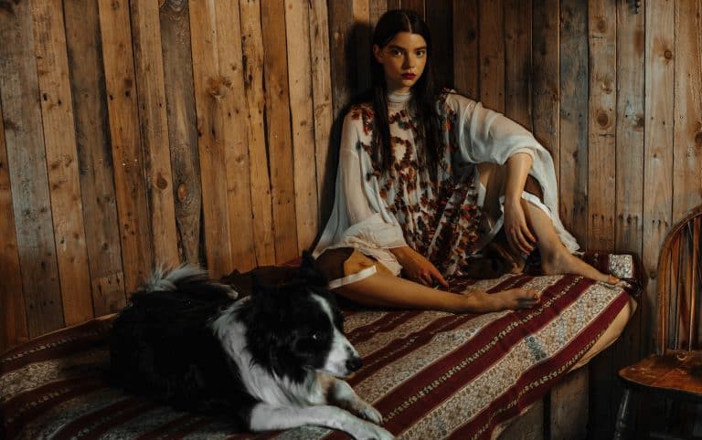 Anya Taylor-Joy: No shoes. Wears a loose dress in sheer fabric with a floral print. Her…
