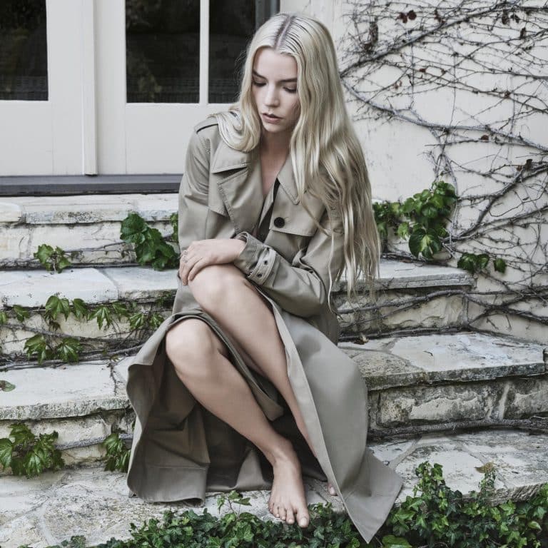 Anya Taylor-Joy: Wears a long beige coat and is barefoot. Her hair is…