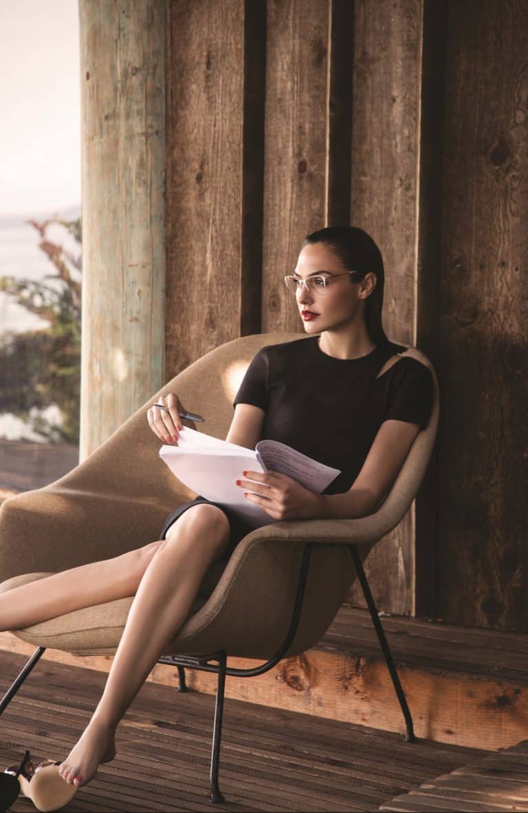 Gal Gadot: Wears a simple, elegant black dress. No shoes on; her heels are…