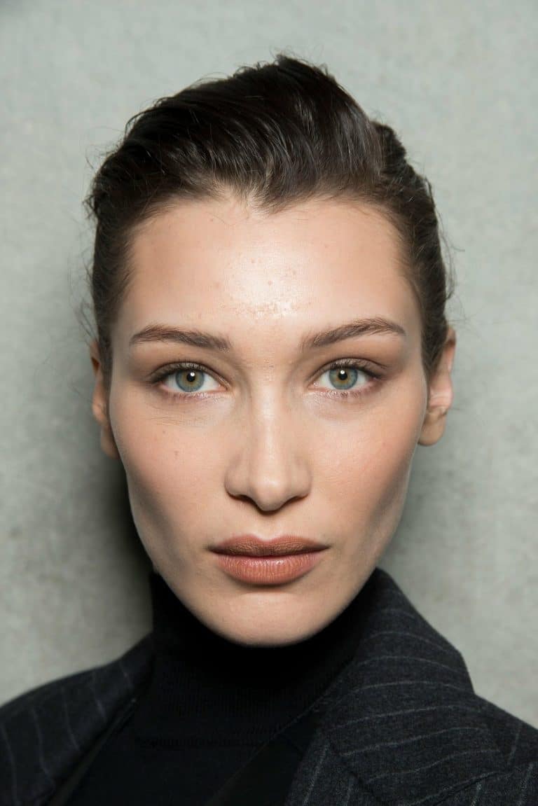 Bella Hadid: No shoes visible. Wears a black turtleneck sweater and a…