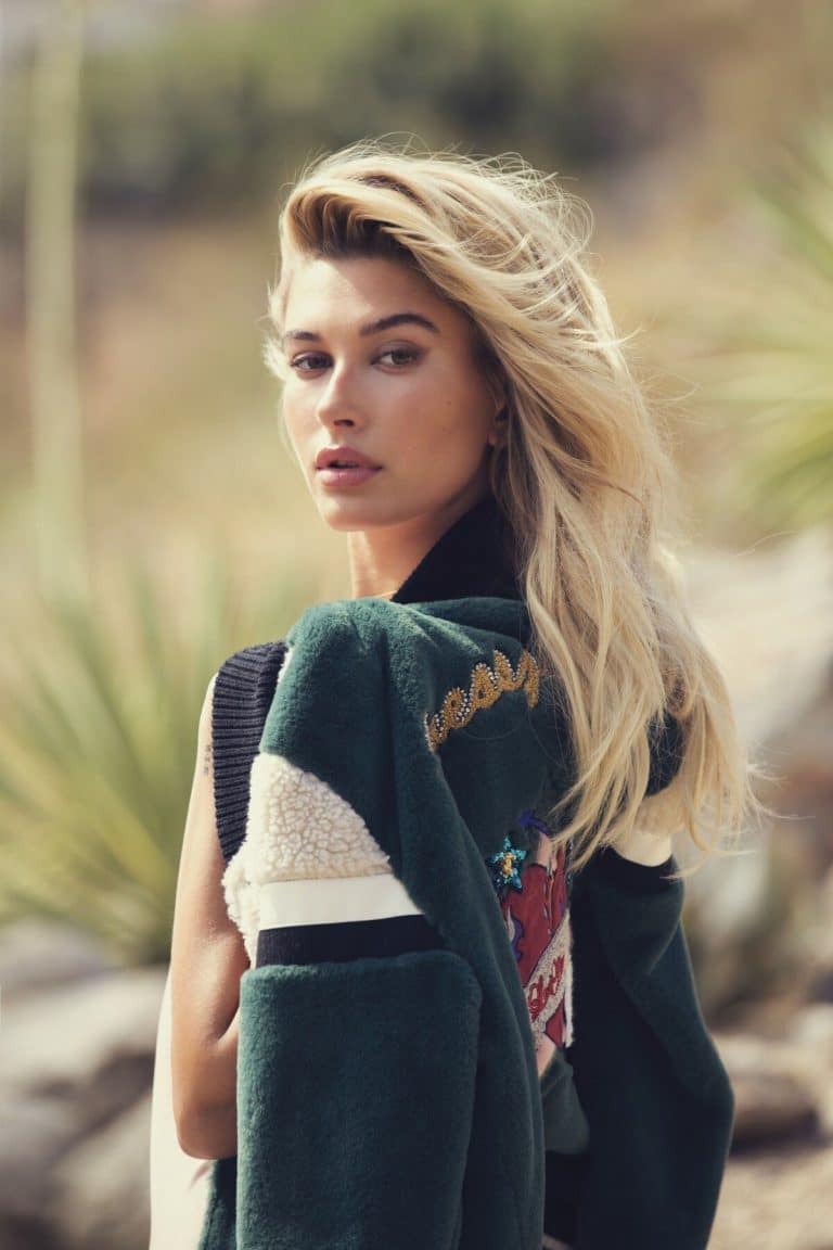 Hailey Baldwin Bieber: Long blonde hair, flowing in the wind. Wearing a black sleeveless…