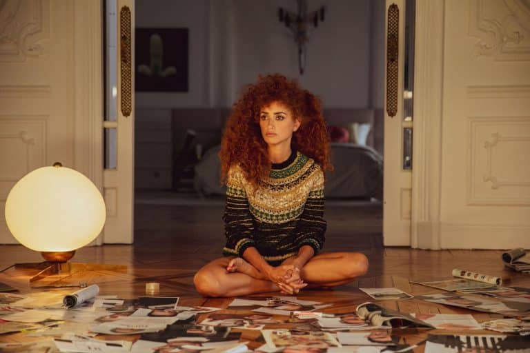 Penélope Cruz: With voluminous curly hair, wears an intricately designed sweater in shades…