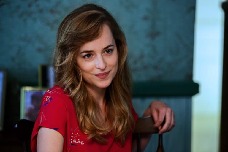 Dakota Johnson: Loose, wavy hair; she wears a red blouse with white and blue details.…