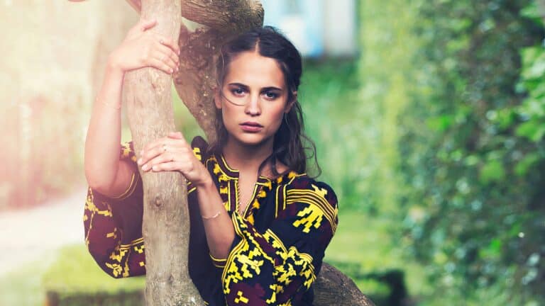 Alicia Vikander: The outfit features a vibrant design with yellow and red patterns over a…