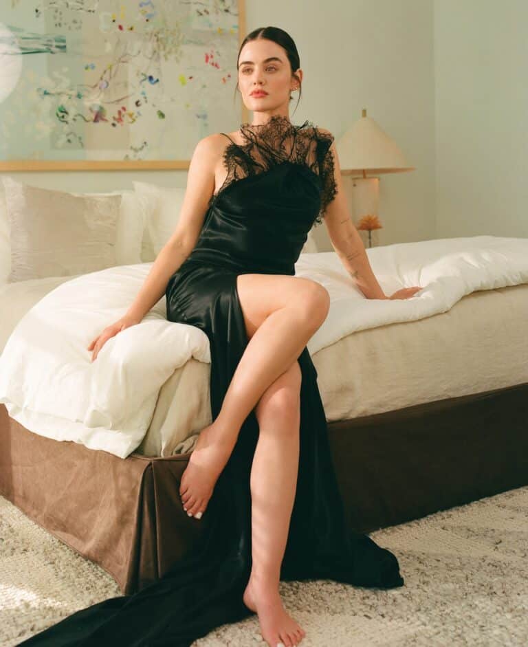 Lucy Hale: Elegant black dress with lace details at the neckline and no visible shoes.…