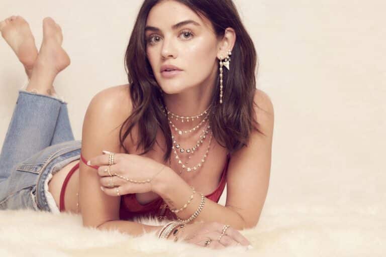 Lucy Hale: Long dark brown wavy hair worn loose, wearing a red T-shirt and light jeans. Wears…
