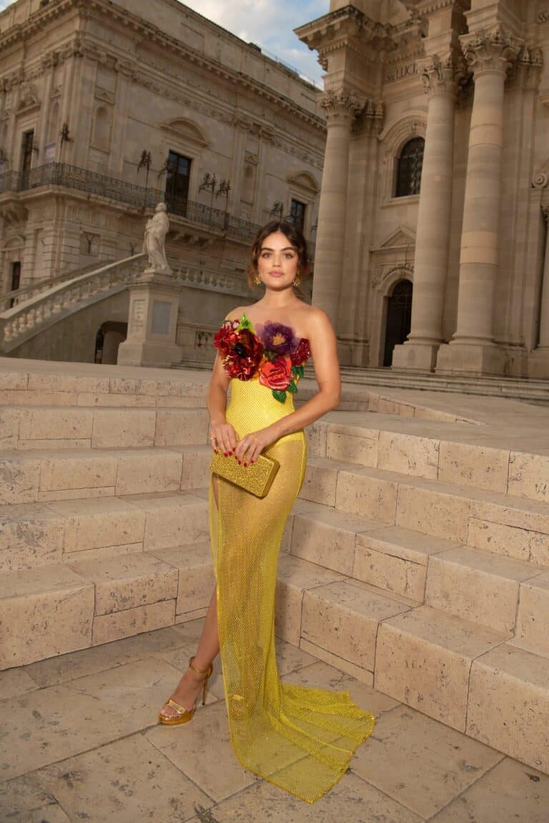 Lucy Hale: Rocks a yellow dress with floral appliqués on the top. Wears sandals…