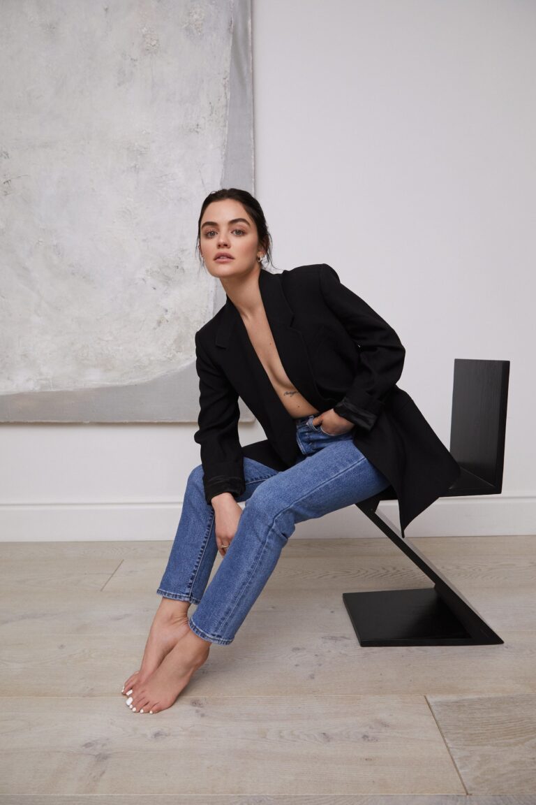 Lucy Hale: Wears a black jacket with nothing underneath, and tight blue jeans. Barefoot. Is…