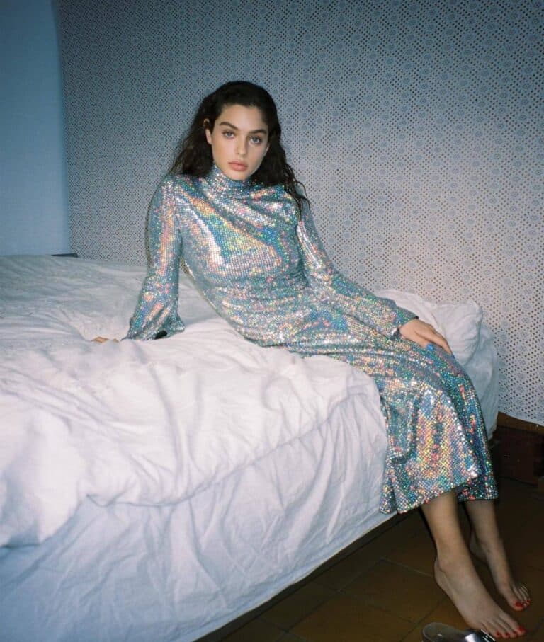 Odeya Rush: An elegant long dress with multicolored sequins sparkles under the light as she rests…