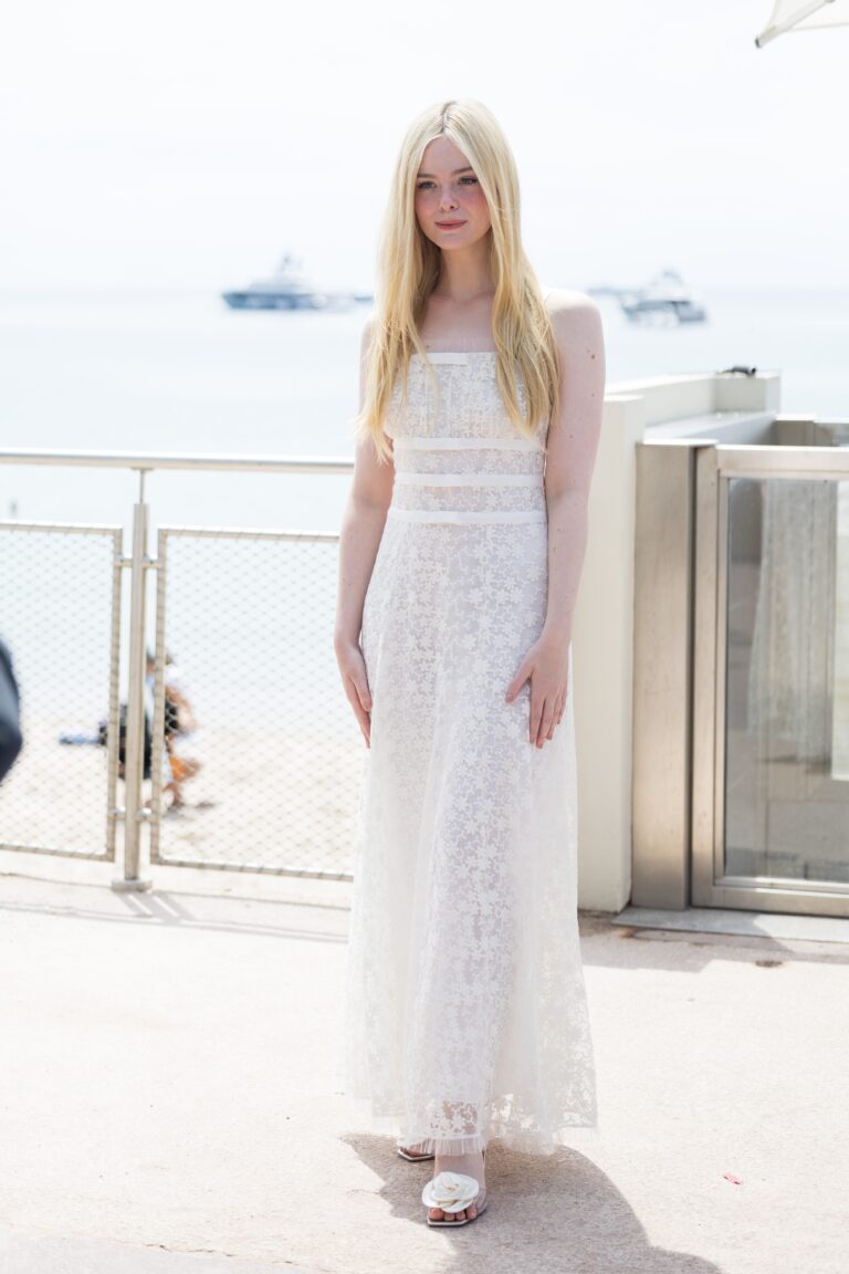 Elle Fanning: Wearing a long white dress with embroidery that stands out for its delicacy. The footwear…