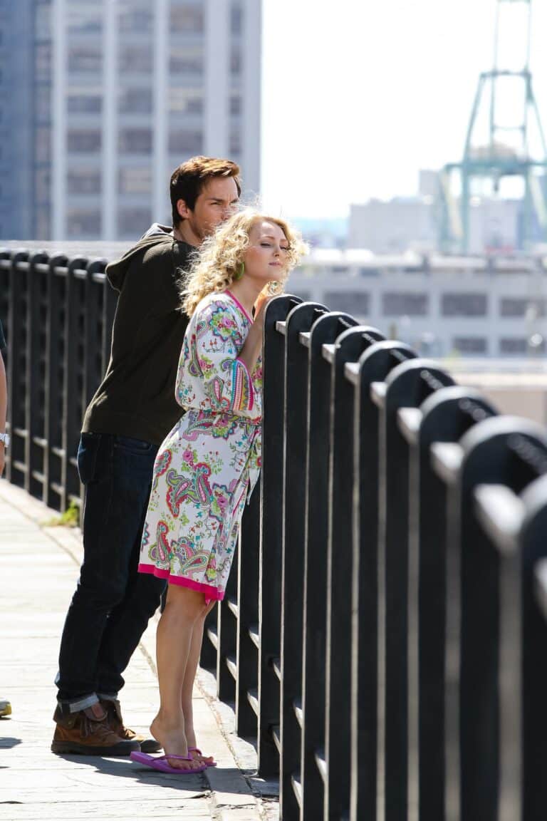 AnnaSophia Robb: A colorful outfit stands out in a floral-print dress with pink details, paired…