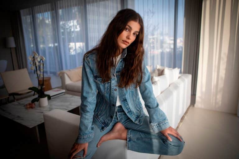 Camila Morrone: Light blue denim jacket and pants set, long loose hair. No…
