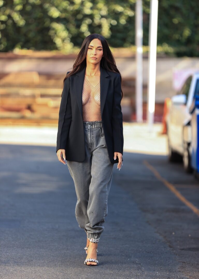 Megan Fox: Wears a black blazer over a shiny mesh top and gray pants…