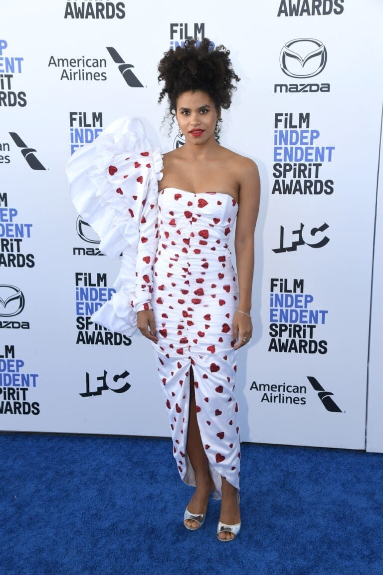 Zazie Beetz: Wears a fitted white dress with red heart details and long sleeves…