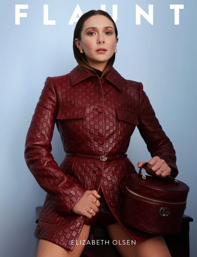 Elizabeth Olsen: Wears a dark red leather coat with an embossed pattern, front button…