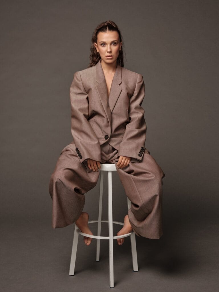 Millie Bobby Brown: Wearing an oversized brown suit, with a broad-shouldered blazer and wide-leg pants.…