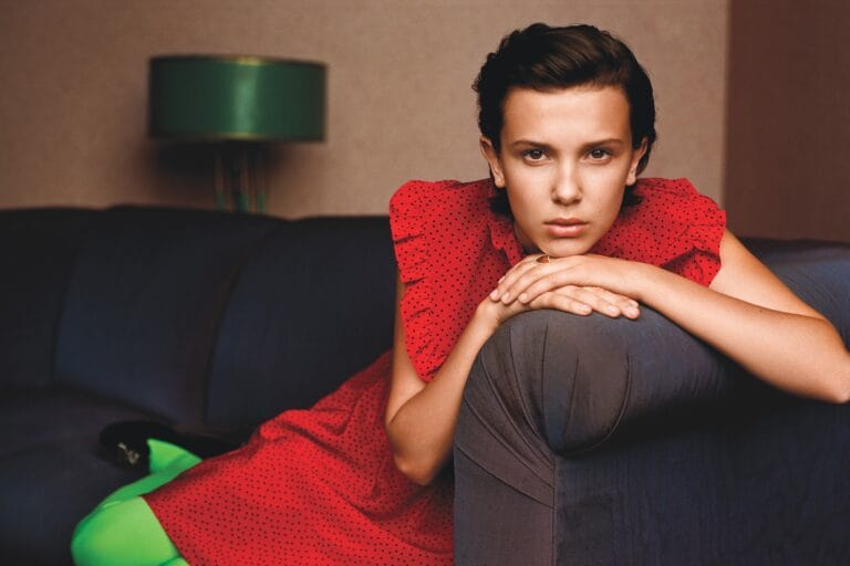 Millie Bobby Brown: Red dress with small black polka dots, trimmed with ruffles on the shoulders. Green tights…