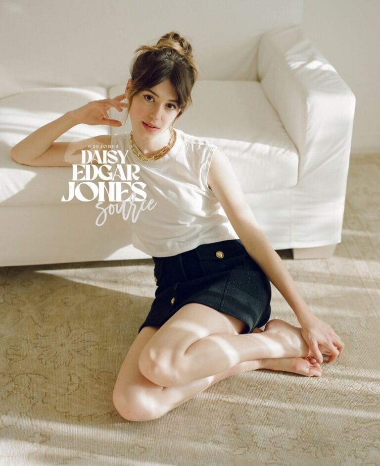 Daisy Edgar-Jones: Sitting on the floor on a light-colored rug, wears a white sleeveless top…