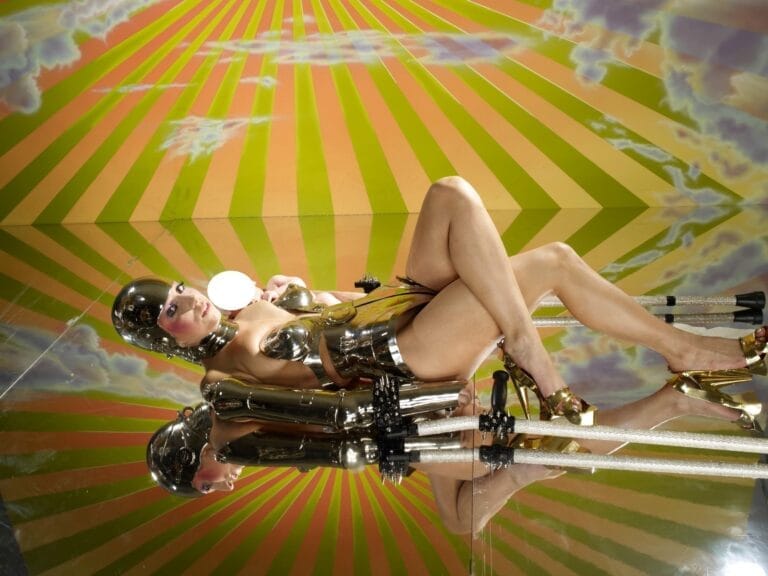 Lady Gaga: Wearing a metallic silver outfit with a futuristic finish that partially covers her body,...