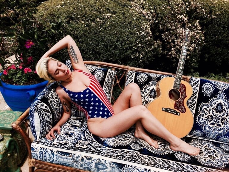 Lady Gaga: Wearing a swimsuit with a US flag design, lying back...