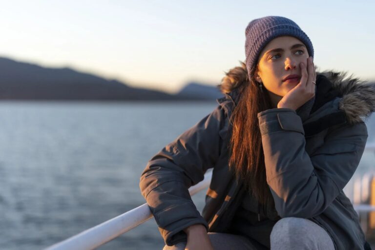 Margaret Qualley: Wears a blue beanie, faux fur hooded jacket and gray pants. Looks…