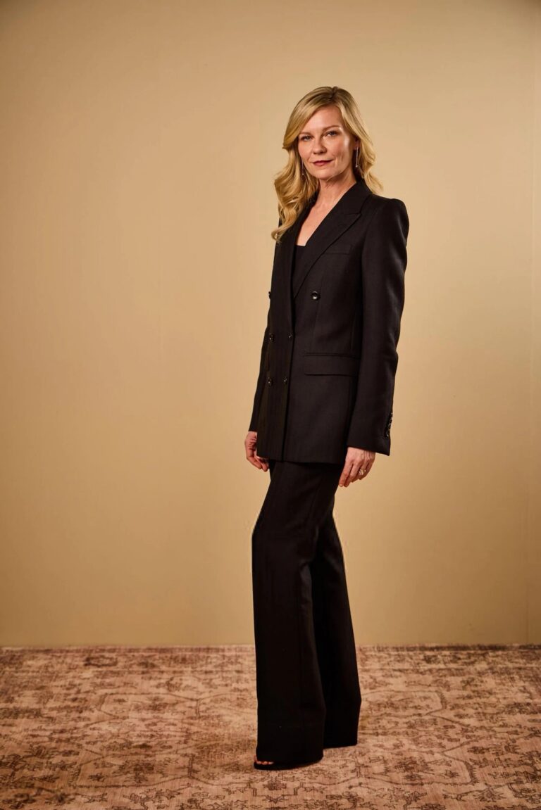 Kirsten Dunst: Wears an elegant black two-piece suit, made up of a fitted blazer and…