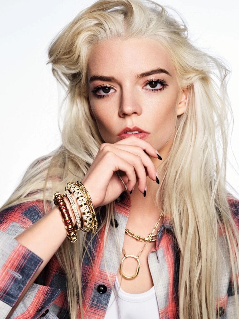 Anya Taylor-Joy: Wears a gray and red plaid shirt with a relaxed, casual touch…