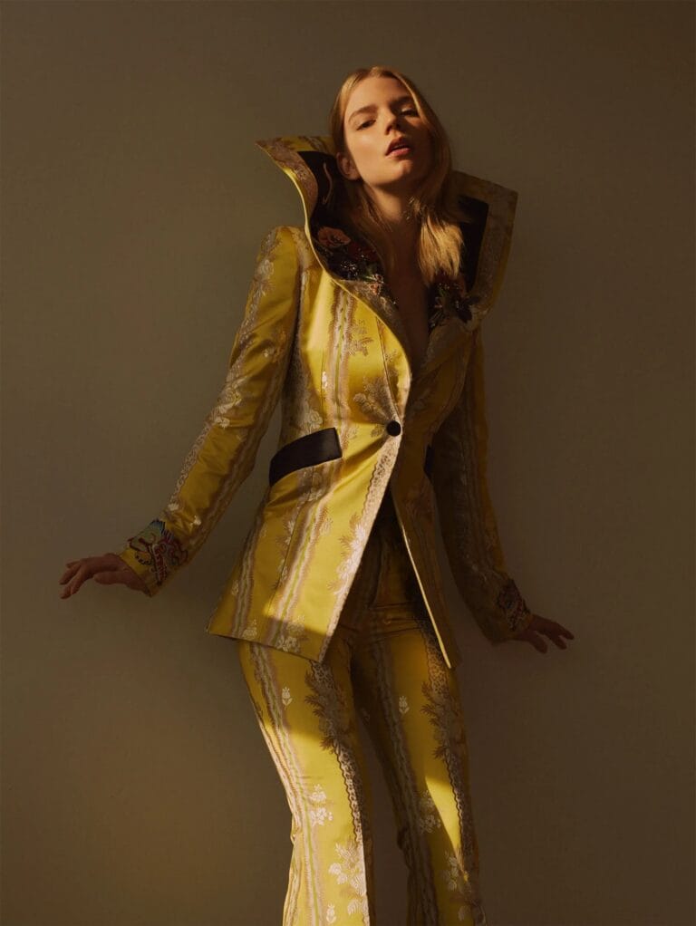 Anya Taylor-Joy: Wears a yellow suit with embroidered details and a large collar, which highlights her…