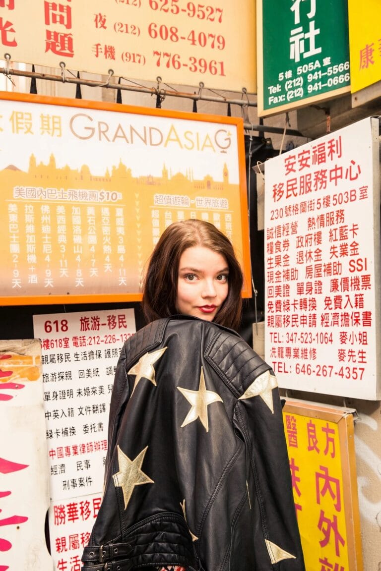 Anya Taylor-Joy: Poses in a black leather jacket adorned with gold stars that highlights her…