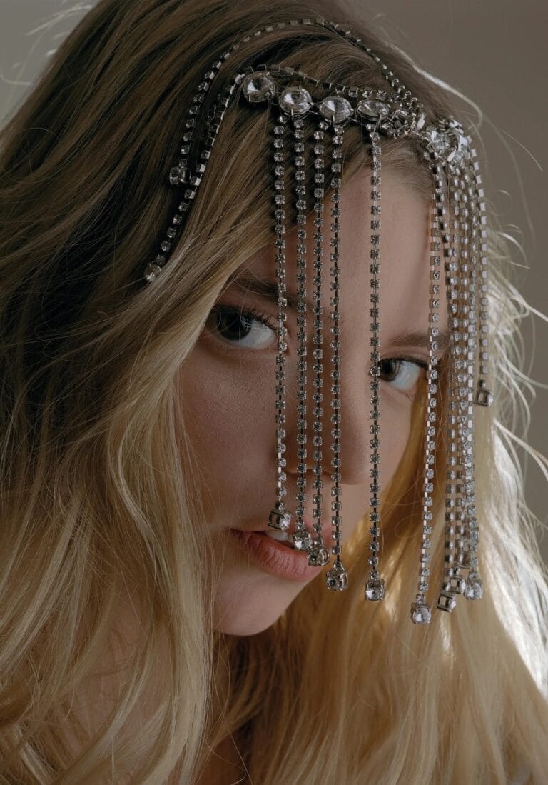 Anya Taylor-Joy: Wears a shiny headpiece with crystal chains falling delicately over…