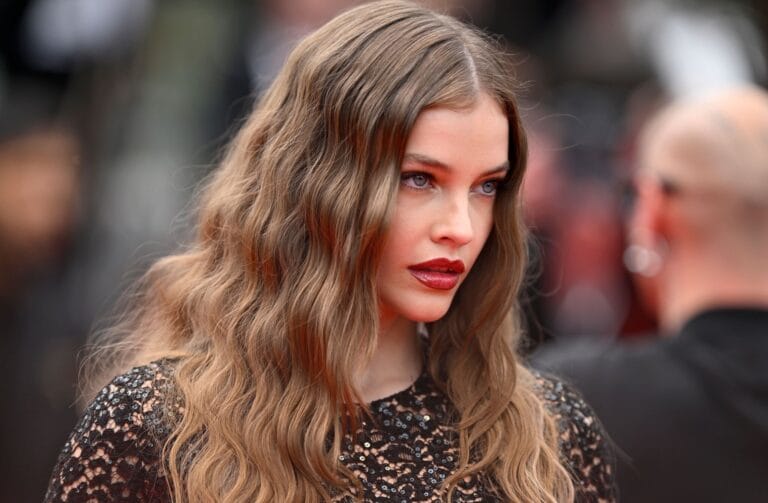 Barbara Palvin: Wears a black dress with shimmering details and sheer panels, showcasing her elegance at a…