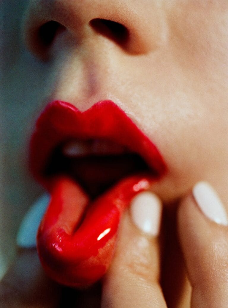 Anya Taylor-Joy: Wears vibrant bright red lips with a glossy finish that catches the…