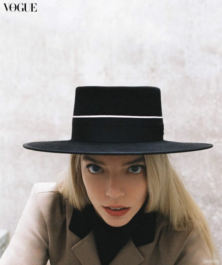 Anya Taylor-Joy: Wears a black wide-brim hat that frames her face, paired with a…
