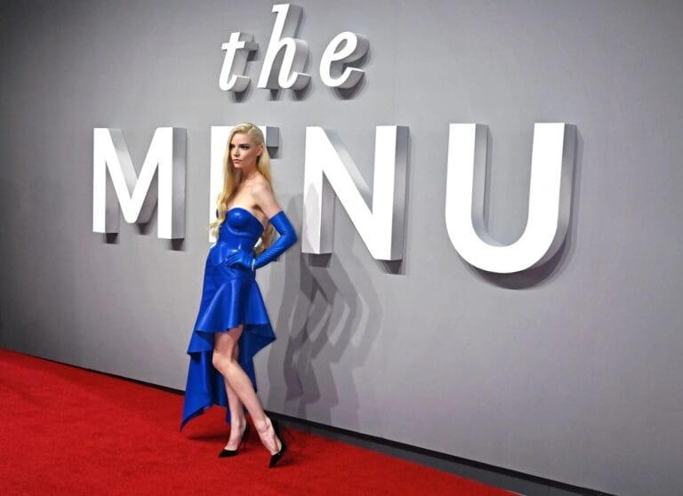 Anya Taylor-Joy: Wears a bright blue dress with an asymmetric cut that highlights her figure, complemented…
