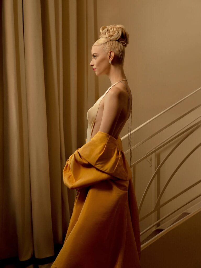 Anya Taylor-Joy: Wears an elegantly cut nude satin dress with an open back that…