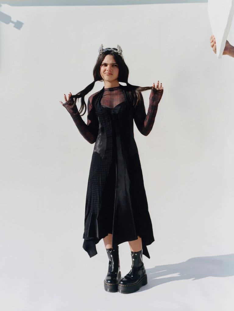 Ariana Greenblatt: Wears an asymmetric black dress with a sheer mesh top that…