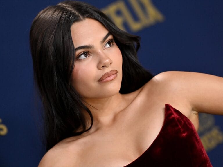 Ariana Greenblatt: Wears a burgundy velvet dress with an asymmetrical cut that highlights one of…
