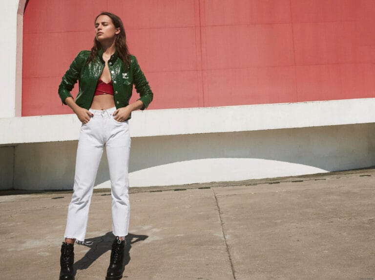 Alicia Vikander: Wears a bright green jacket over a red top, boldly paired with white jeans…