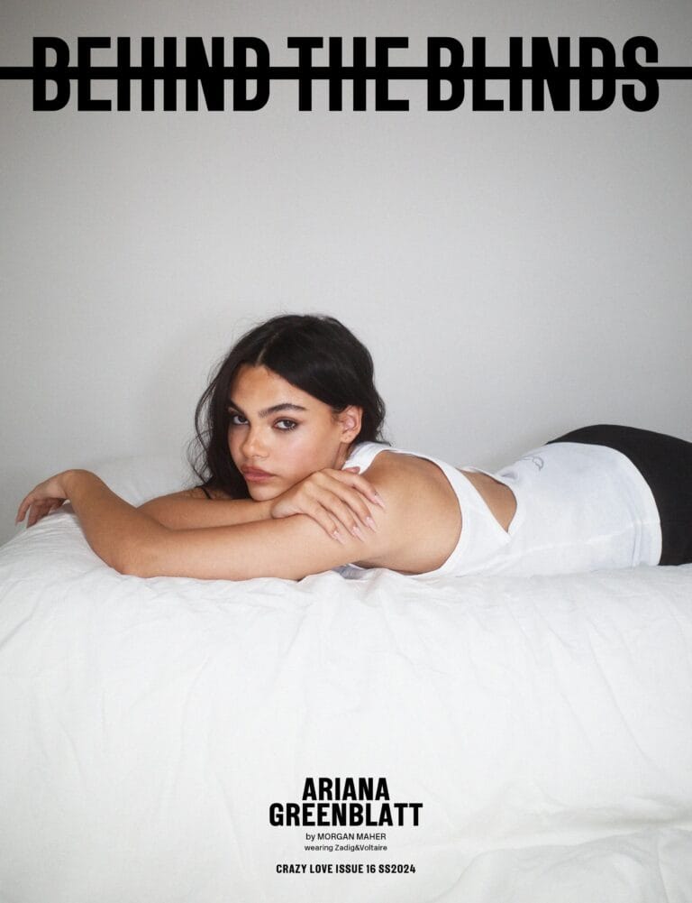 Ariana Greenblatt: Wears a fitted white tank top, lying on a bed with white sheets.…