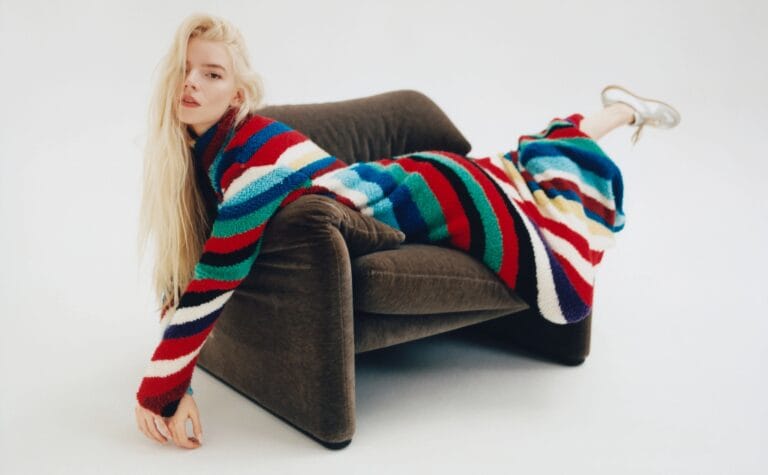 Anya Taylor-Joy: Wears a multicolored knit dress with vibrant stripes, lying down in a…