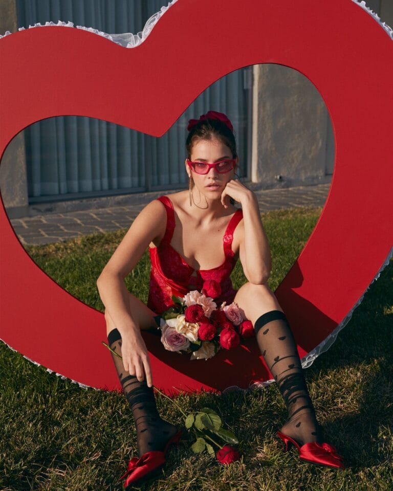 Barbara Palvin: Wears a red lace dress, red sunglasses and a bow…