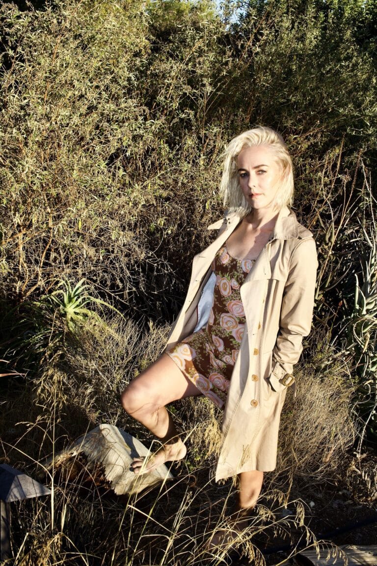 Jena Malone: Wearing a fitted dress with a floral print in brown and pink tones, complemented…